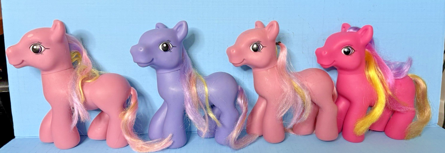 Four 6″ Pony Figures, purple, bright pink, & two light pink, brushable hair
